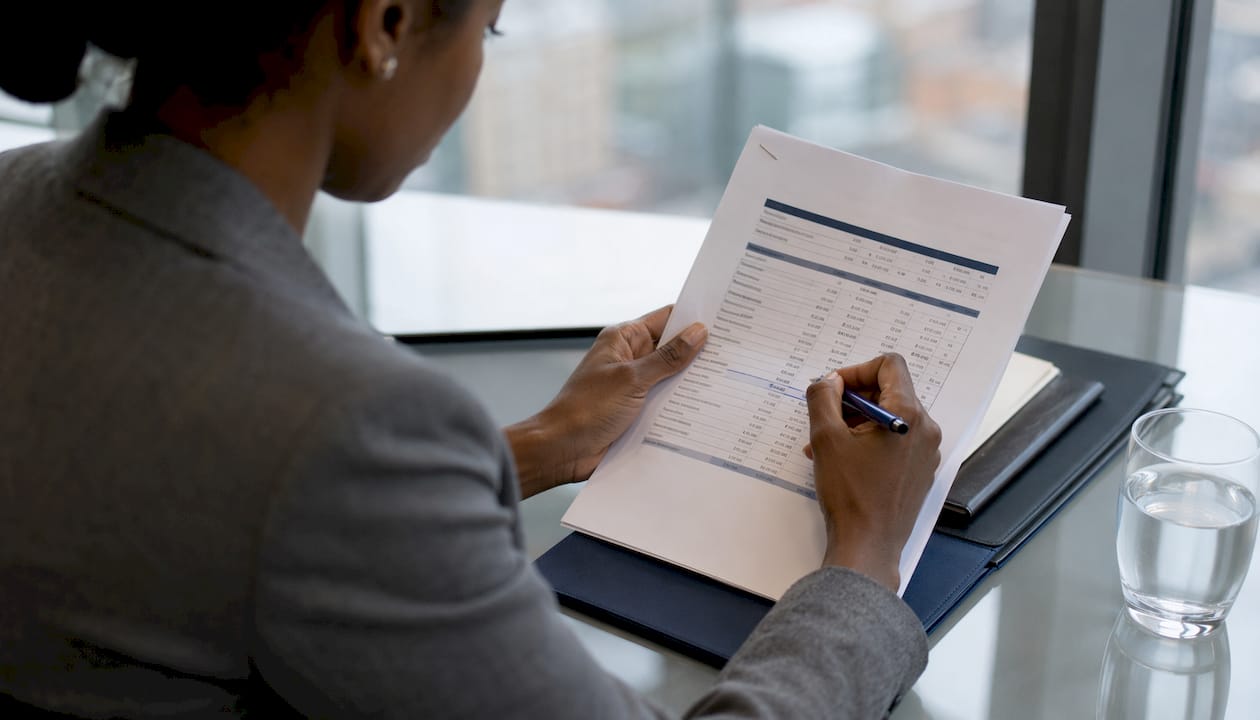 Hands pointing at property valuation report numbers